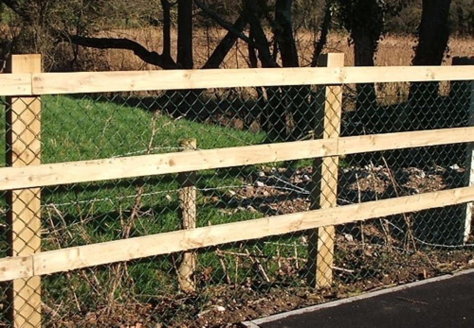 Post and three rail fence with chain link